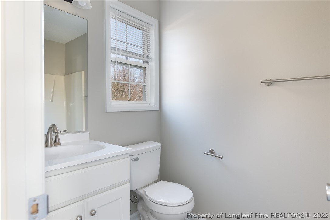 1119 Live Oak Road Coats, NC 27521 - Photo 18 of 23 a white toilet sitting next to a bathroom sink
