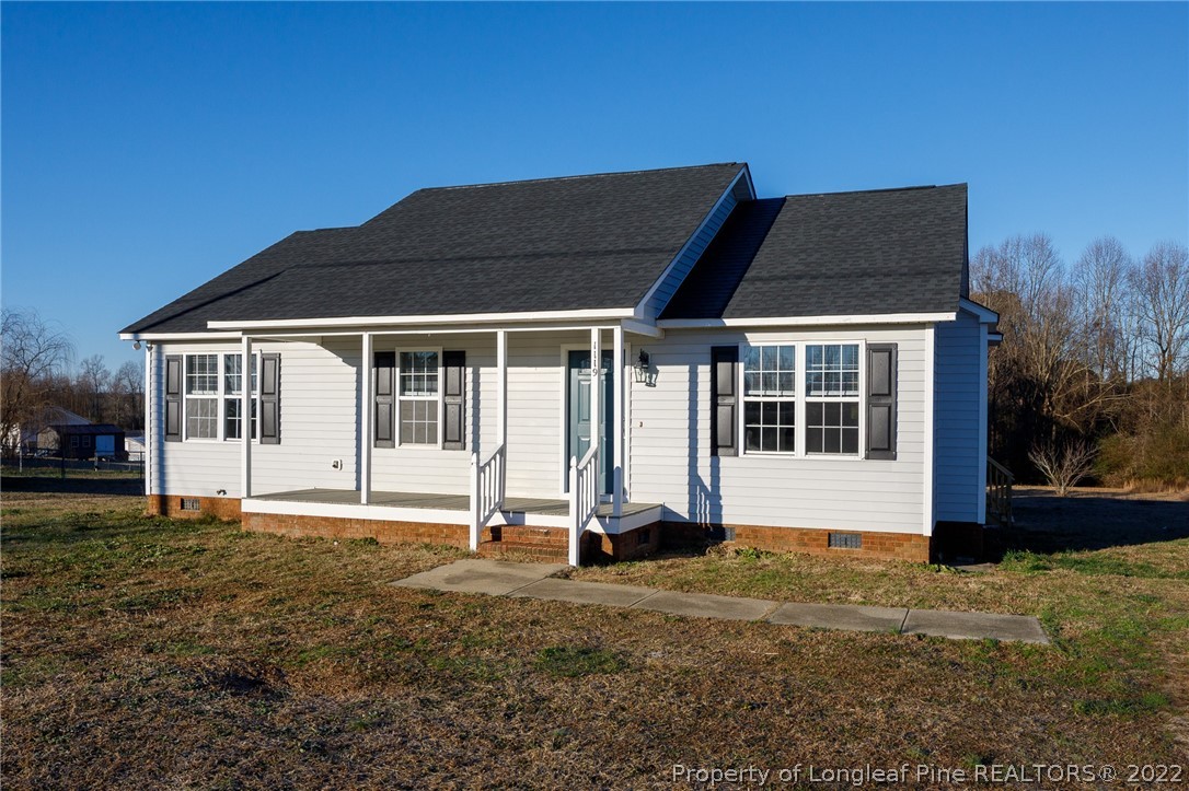 1119 Live Oak Road Coats, NC 27521 - Photo 2 of 23 a front view of a house with a yard