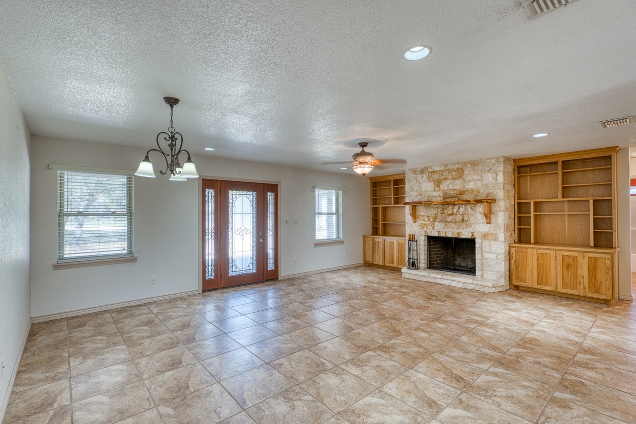 1129 Lonesome Loop Blanco, TX 78606 - Photo 6 of 40 Living room with stone fireplace
