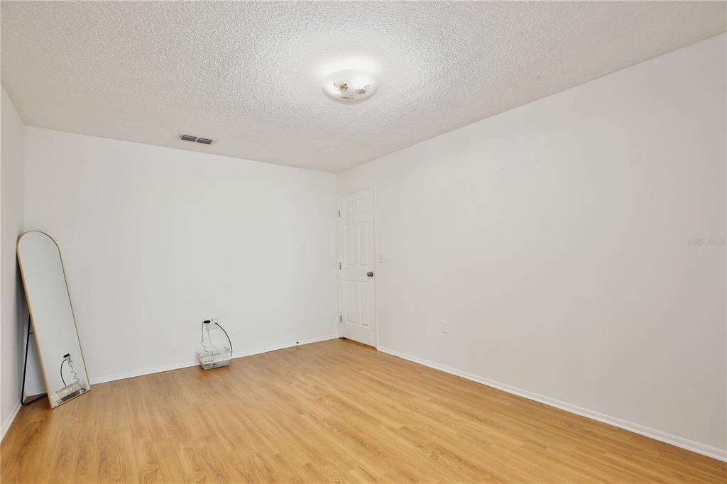 1179 Shadow Run Drive Lakeland, FL 33813 - Photo 14 of 42 a view of empty room with wooden floor