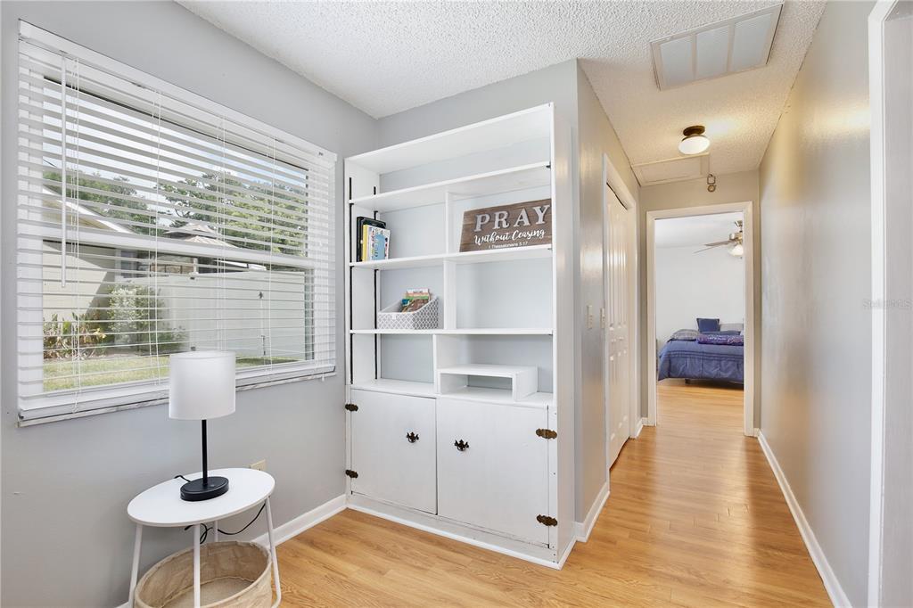 1179 Shadow Run Drive Lakeland, FL 33813 - Photo 19 of 42 a view of a hallway with wooden floor and a cabinet