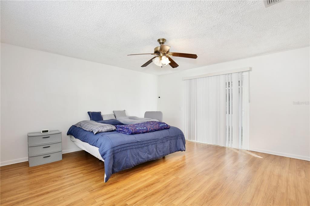 1179 Shadow Run Drive Lakeland, FL 33813 - Photo 20 of 42 a spacious bedroom with a bed and a chandelier