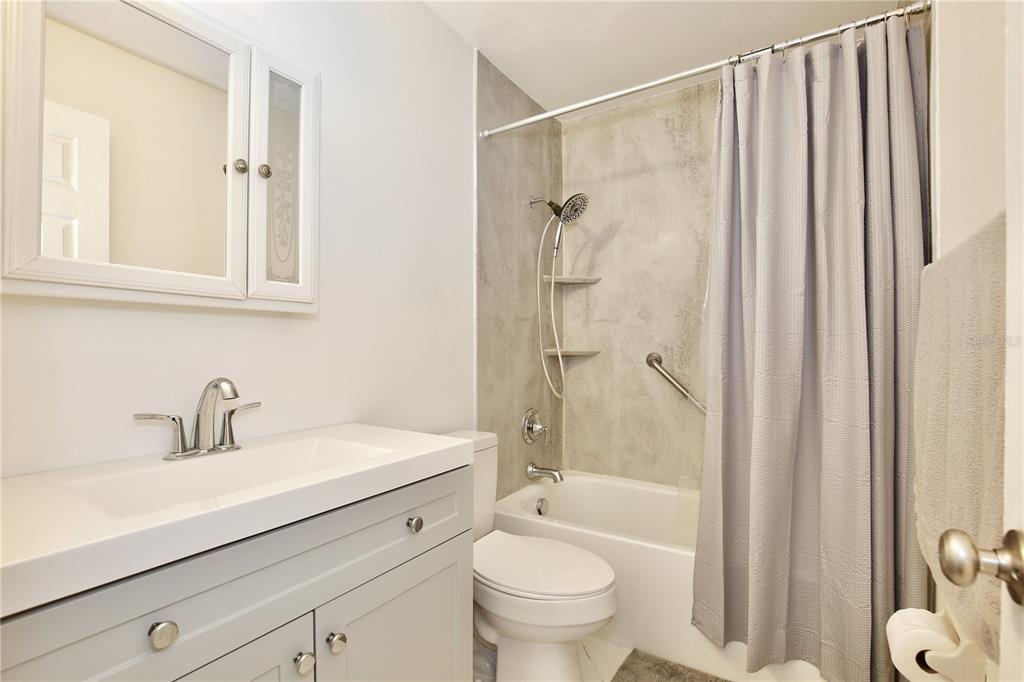 1179 Shadow Run Drive Lakeland, FL 33813 - Photo 24 of 42 a bathroom with a sink a toilet and shower