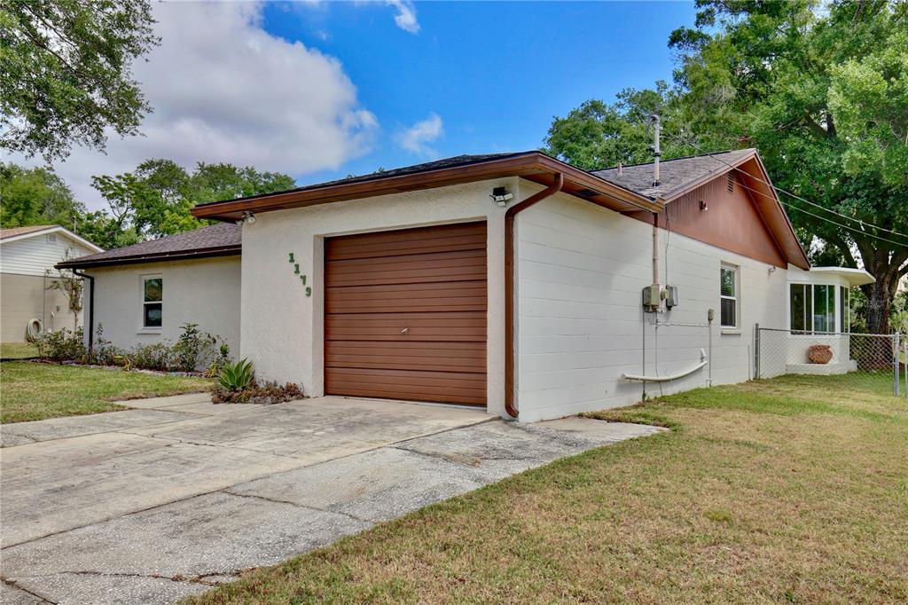 1179 Shadow Run Drive Lakeland, FL 33813 - Photo 4 of 42 a front view of house with yard and trees in the background