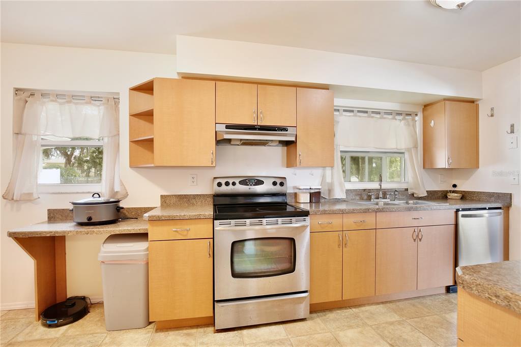 1179 Shadow Run Drive Lakeland, FL 33813 - Photo 9 of 42 a kitchen with a stove top oven sink and cabinets