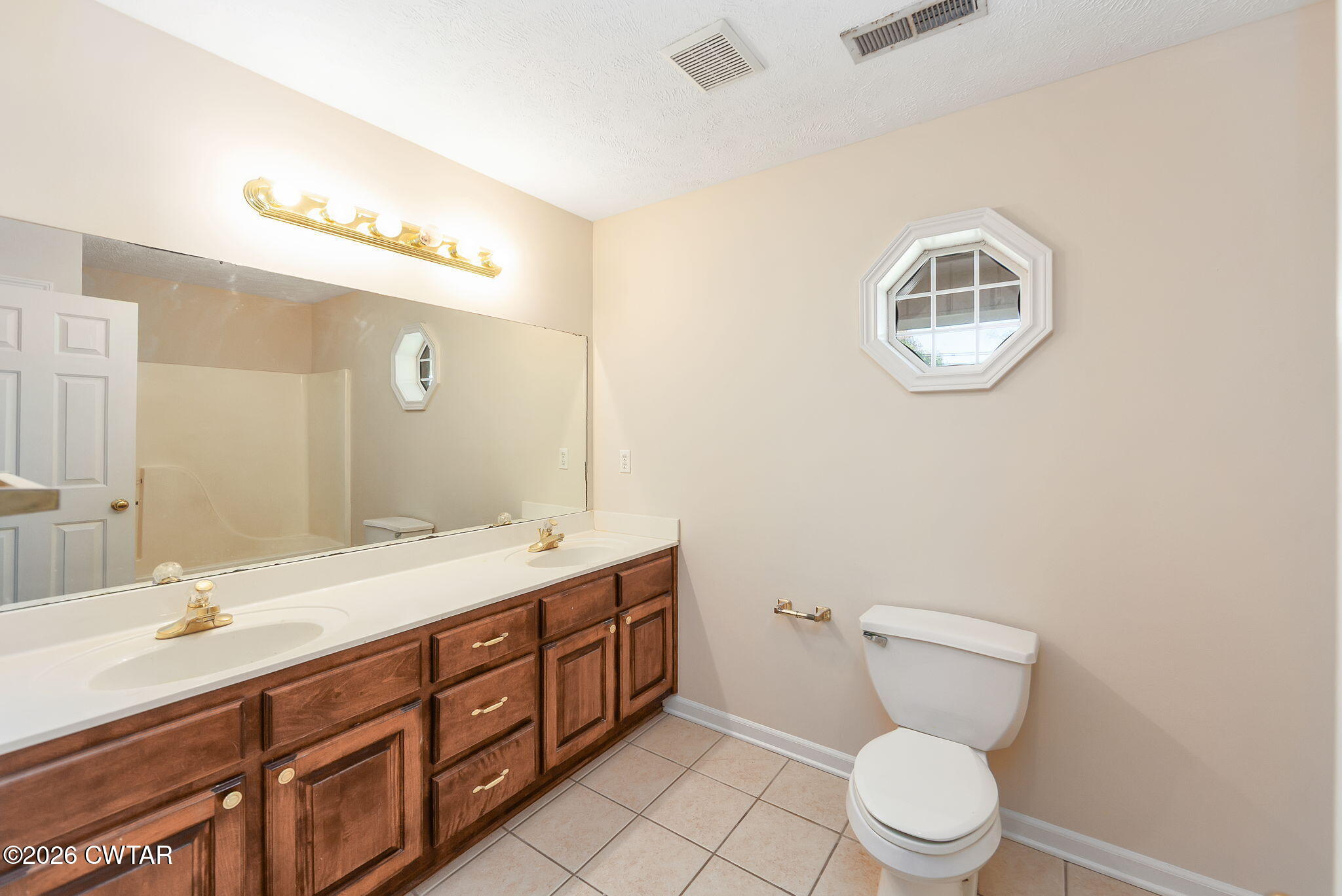8 Sebastian Drive Jackson, TN 38305 - Photo 20 of 23 a bathroom with a double vanity sink toilet and a mirror