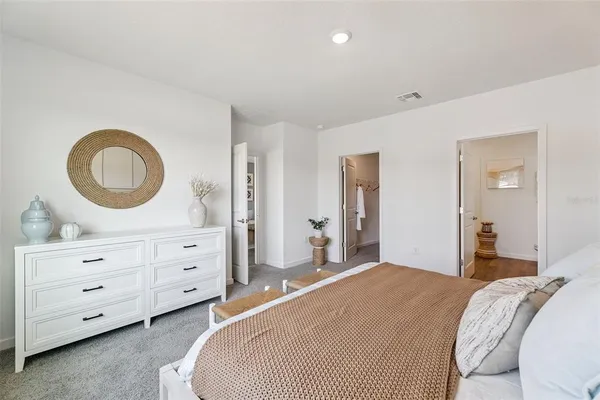 a bedroom with a bed and a dresser