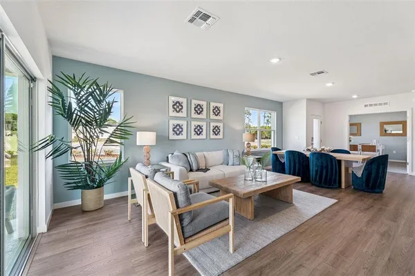 a living room with furniture potted plant and a table