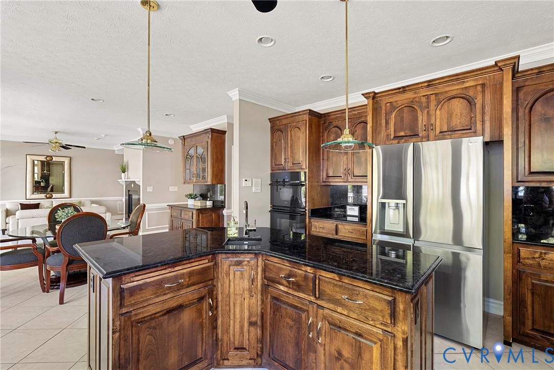 5213 Clipper Cove Road Midlothian, VA 23112 - Photo 23 of 73 The kitchen features rich wood cabinetry, dark cou
