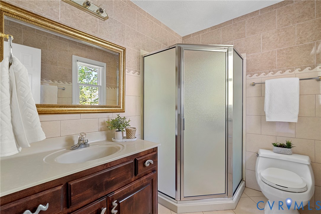 5213 Clipper Cove Road Midlothian, VA 23112 - Photo 41 of 73 The bathroom features a corner shower with frosted