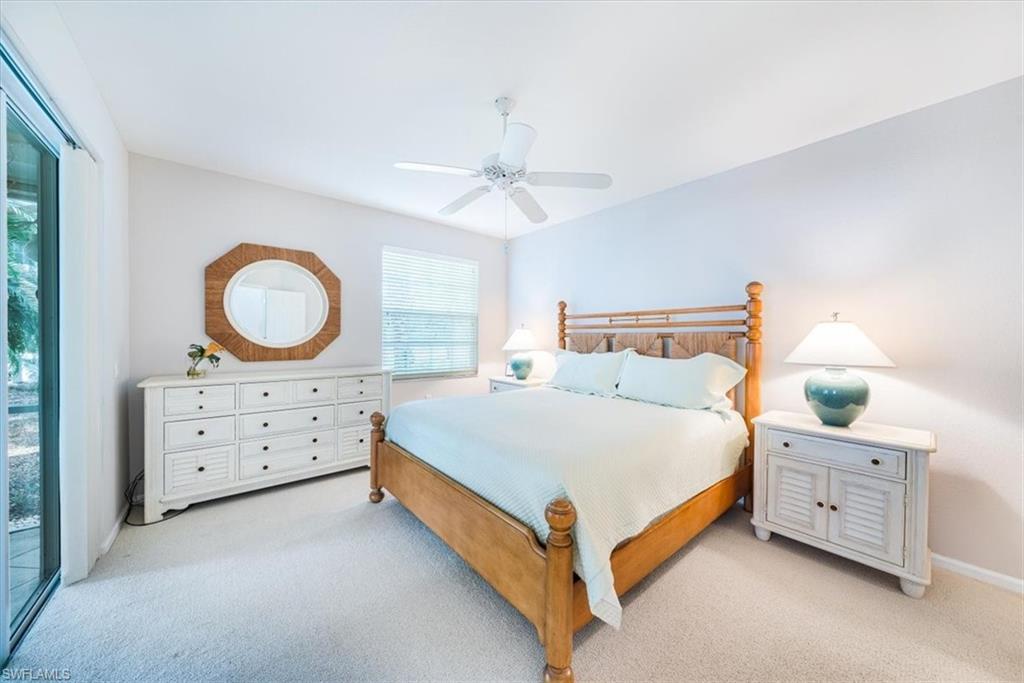 7120 Timberland Circle, Unit 101 Naples, FL 34109 - Photo 11 of 24 a bed room with a bed and a dresser