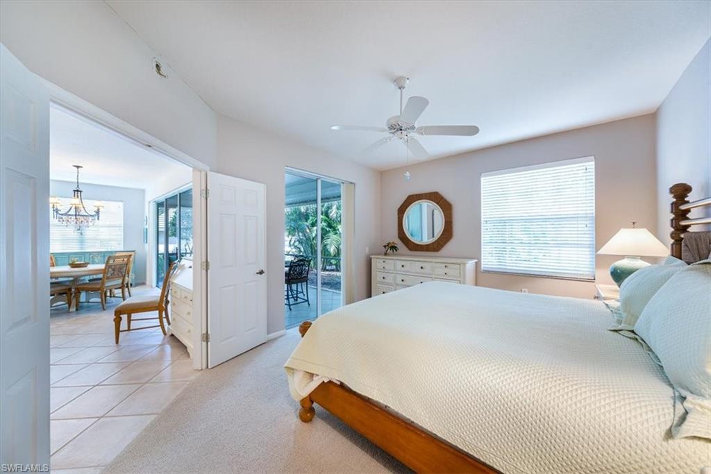 7120 Timberland Circle, Unit 101 Naples, FL 34109 - Photo 12 of 24 a bed sitting in a spacious bedroom next to a window and a larger closet