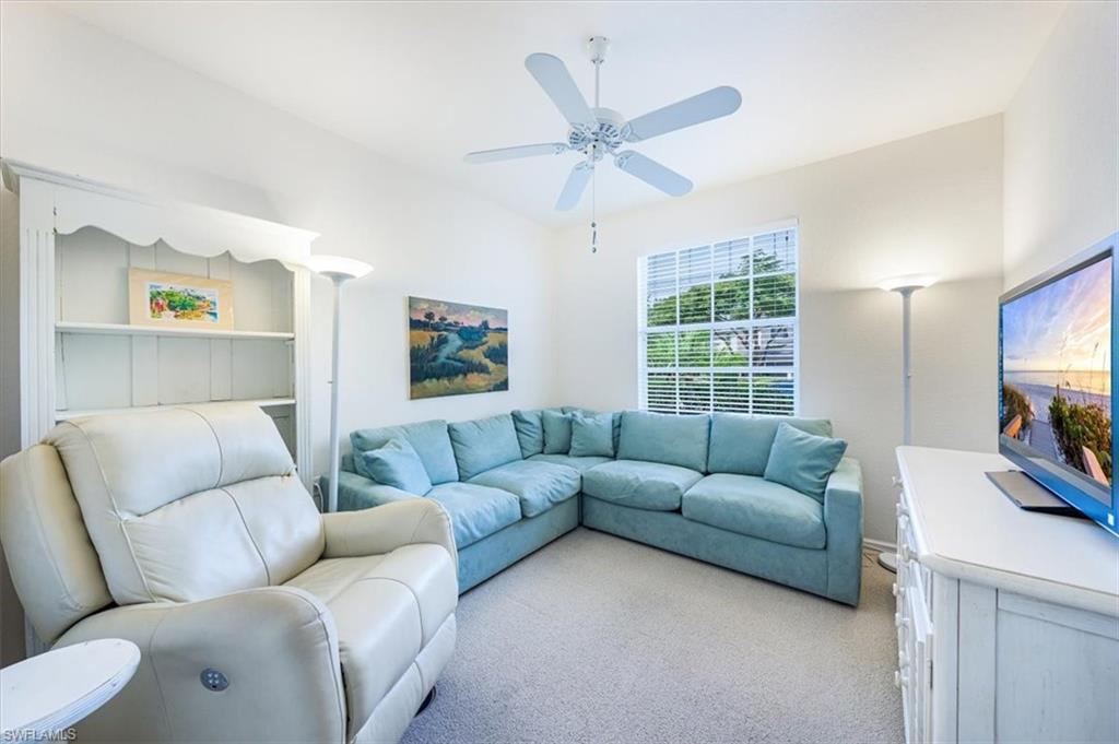 7120 Timberland Circle, Unit 101 Naples, FL 34109 - Photo 15 of 24 a living room with furniture and a flat screen tv