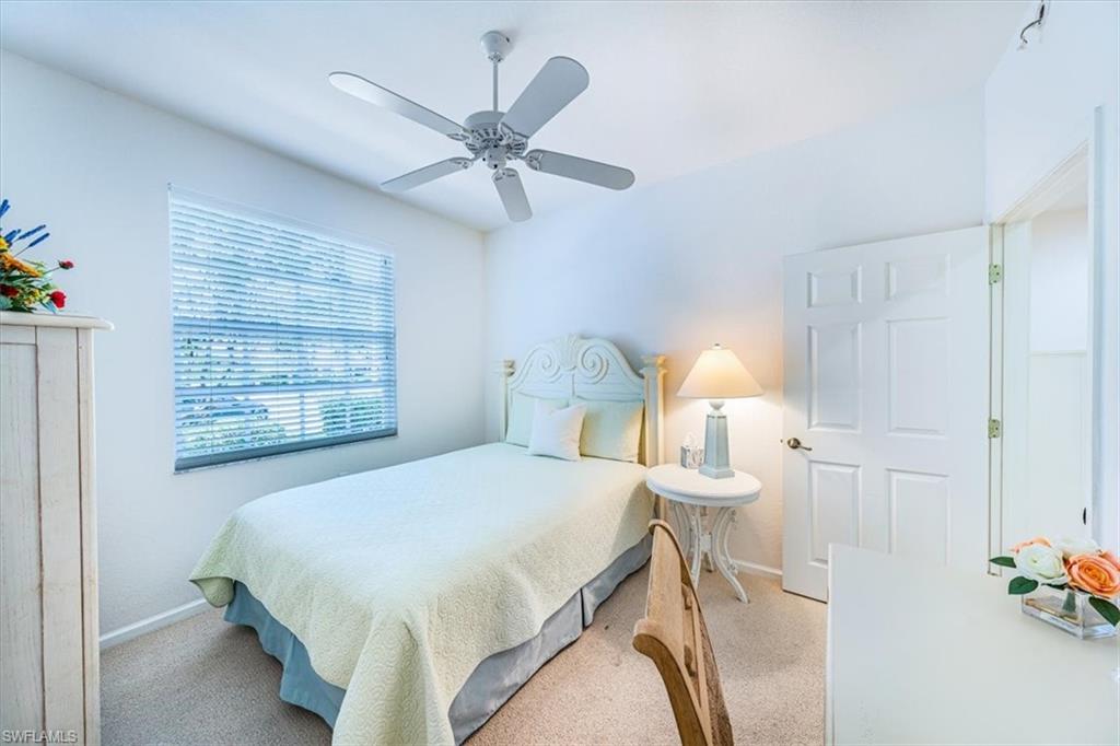 7120 Timberland Circle, Unit 101 Naples, FL 34109 - Photo 16 of 24 a bedroom with a bed and a window