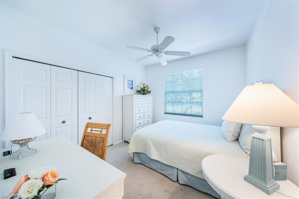7120 Timberland Circle, Unit 101 Naples, FL 34109 - Photo 18 of 24 a bedroom with a bed and a lamp