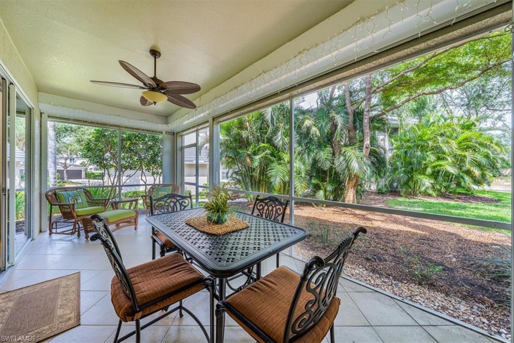 7120 Timberland Circle, Unit 101 Naples, FL 34109 - Photo 20 of 24 a view of a patio with a table chairs and a backyard