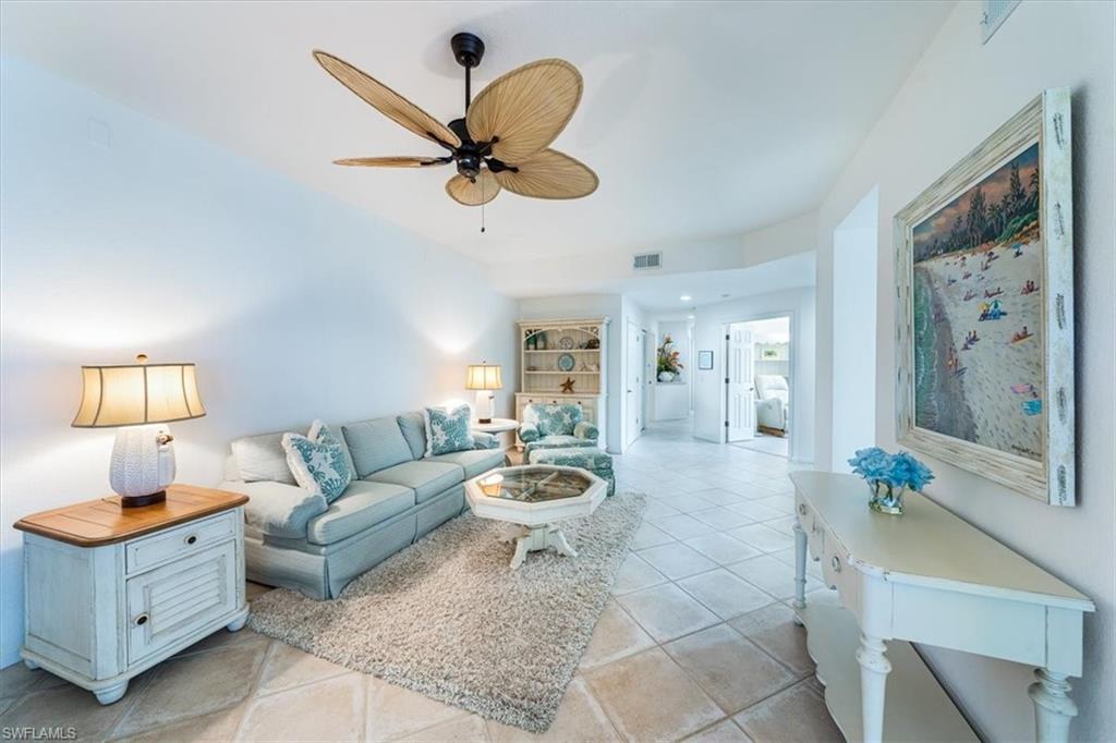 7120 Timberland Circle, Unit 101 Naples, FL 34109 - Photo 2 of 24 a living room with furniture and a large window