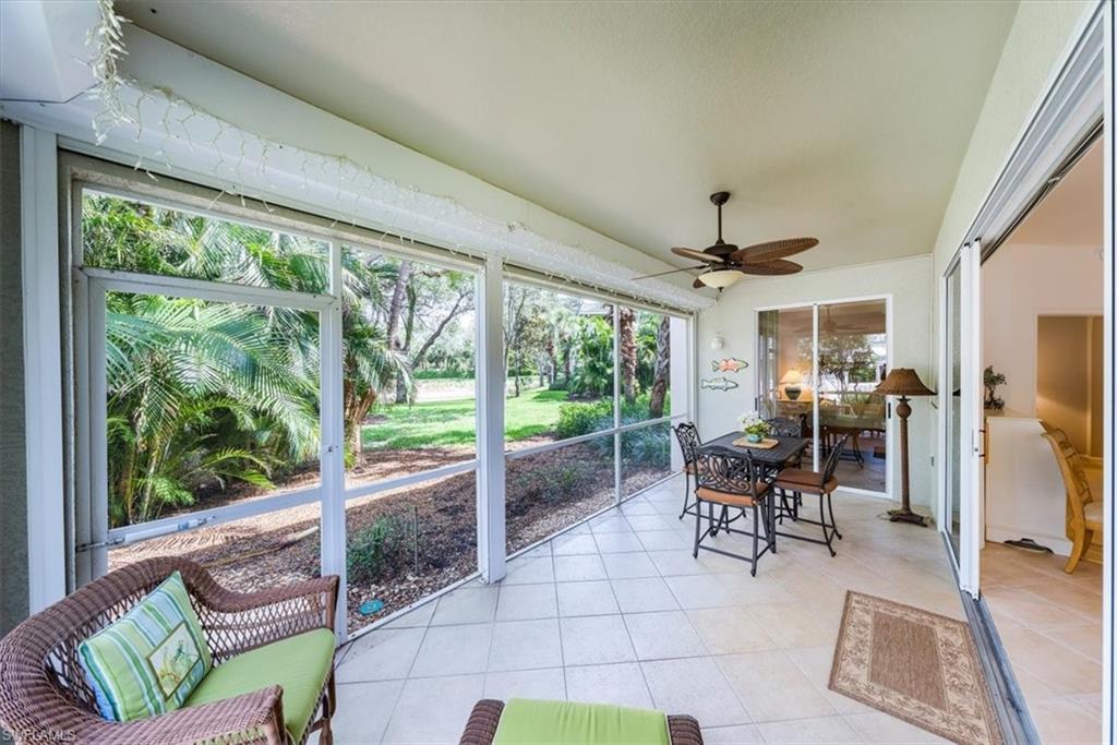 7120 Timberland Circle, Unit 101 Naples, FL 34109 - Photo 21 of 24 a living room with furniture tv and a large window