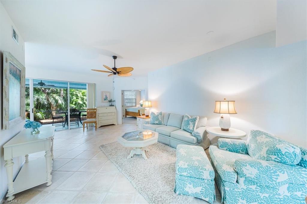 7120 Timberland Circle, Unit 101 Naples, FL 34109 - Photo 3 of 24 a living room with furniture and a large window