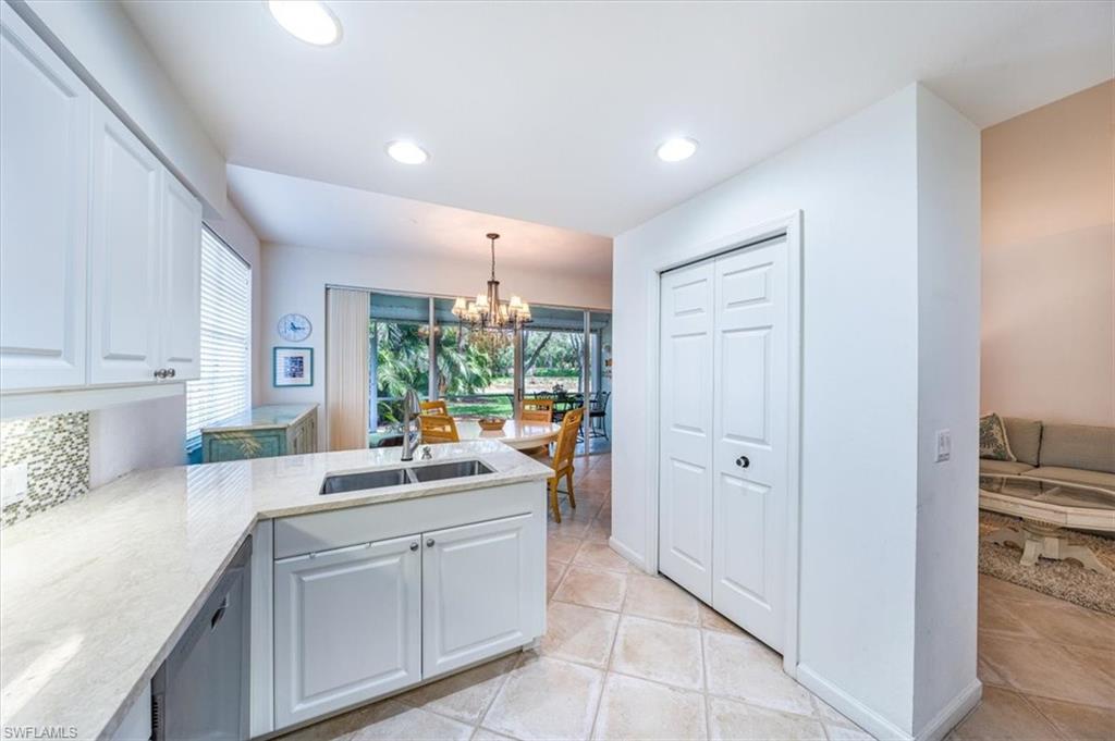 7120 Timberland Circle, Unit 101 Naples, FL 34109 - Photo 7 of 24 a kitchen with white cabinets and window