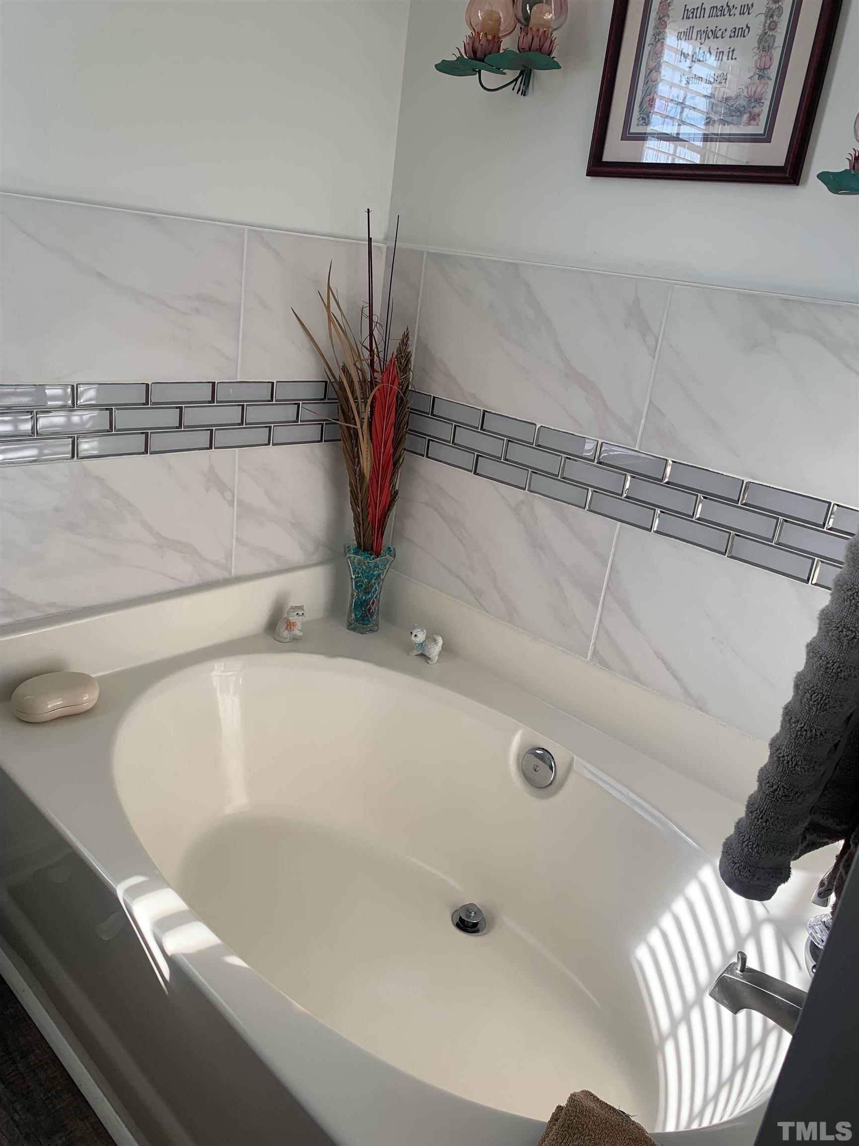 1104 Feldmen Drive Raleigh, NC 27603 - Photo 13 of 23 a bath tub sitting next to a bathroom sink
