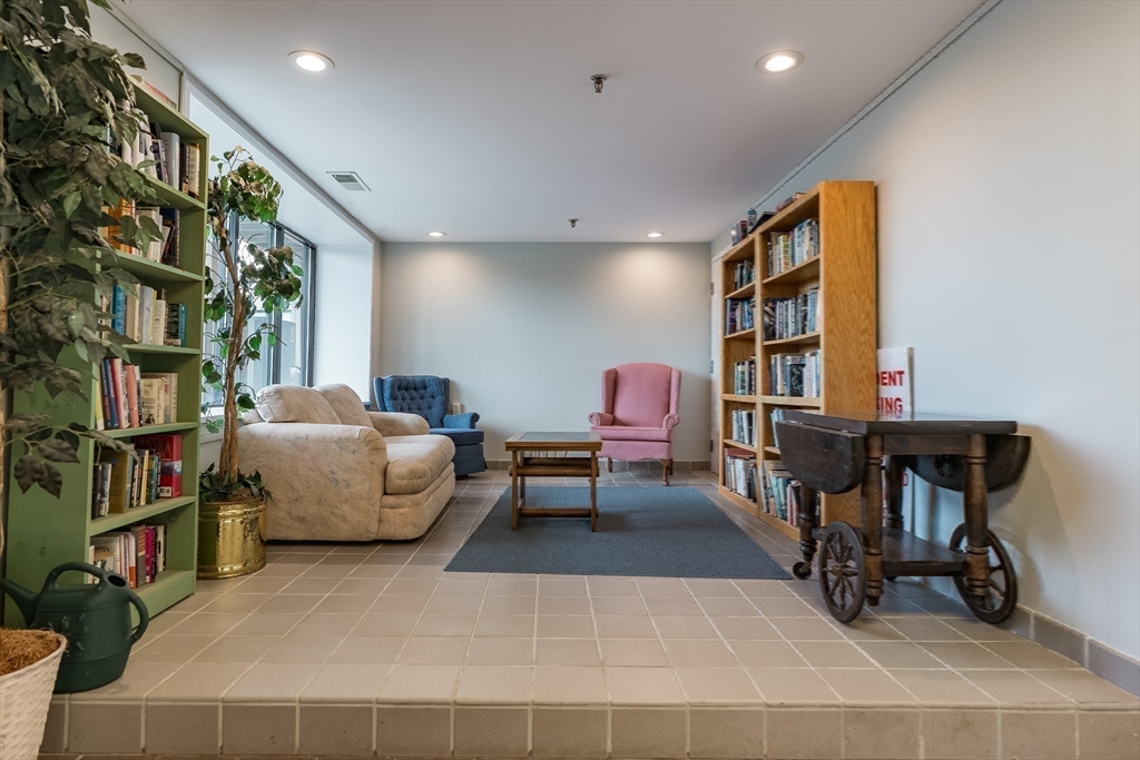45 Main Street, Unit 112 Wareham, MA 02571 - Photo 25 of 30 a living room with furniture a bookshelf and a large window