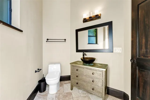 a view of bathroom with a sink and mirror