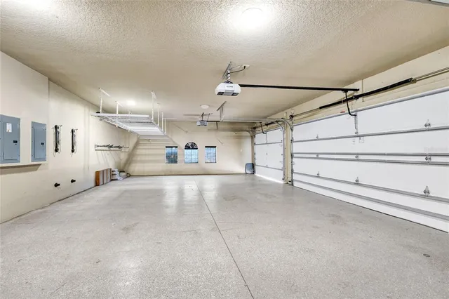 a bathroom with a granite countertop bathtub shower sink mirror and toilet