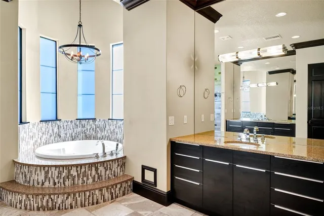 an aerial view of a house with a garden and lake view