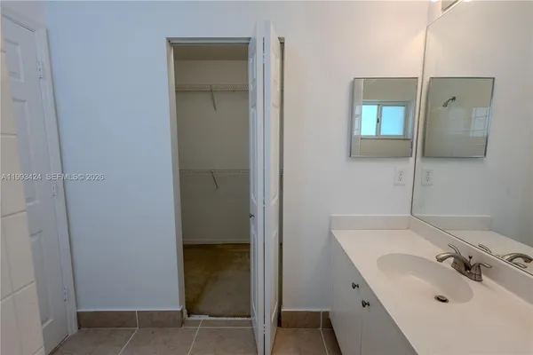 an aerial view of a house with a garden and lake view