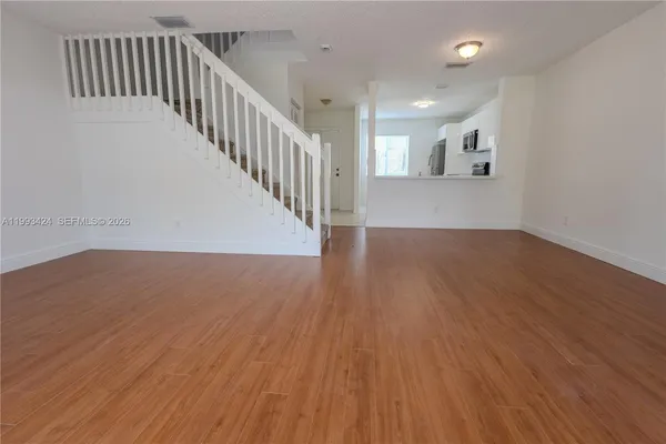 a white toilet sitting next to a white sink and vanity