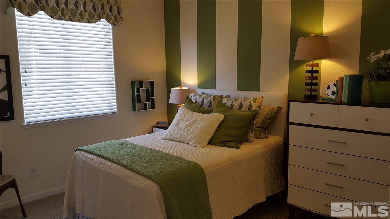 2375 Soprano Drive Reno, NV 89521 - Photo 6 of 6 a bed sitting in a bedroom next to a window