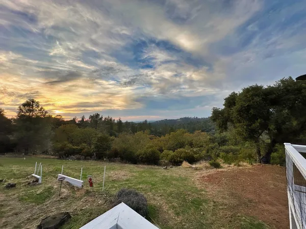 a view of a street with next to a yard