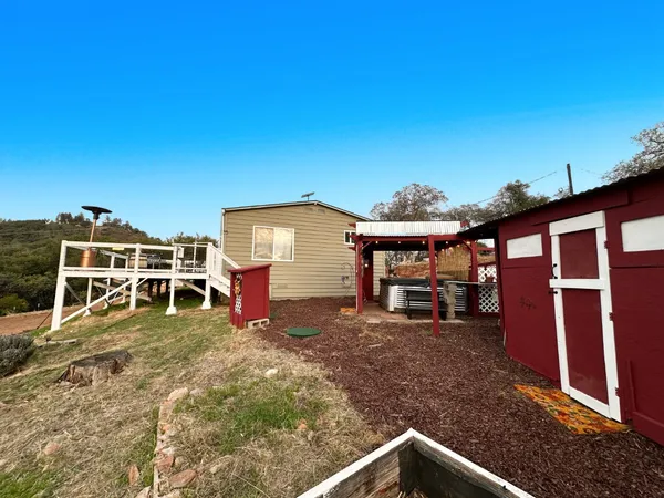 a view of a house with a yard porch and sitting area