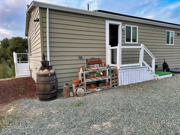 a view of a chairs and table in the backyard