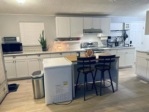 a kitchen with a sink cabinets and window