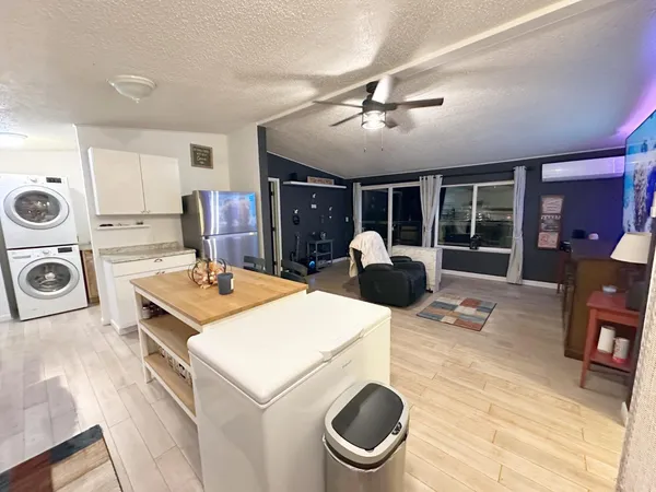 a kitchen with a stove a sink a microwave and cabinets