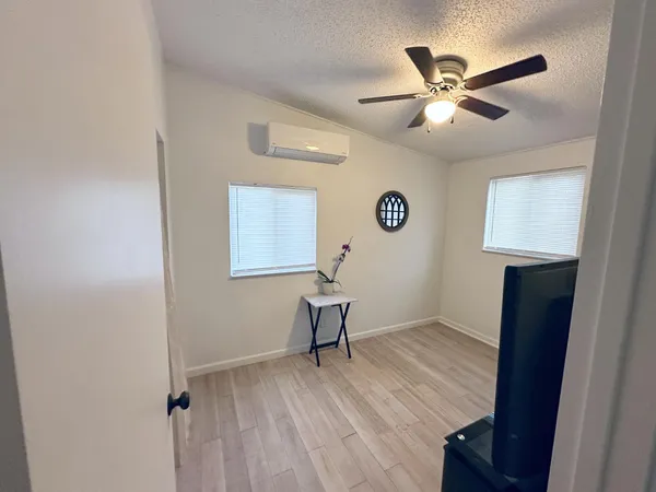 a view of room with wooden floor and workspace