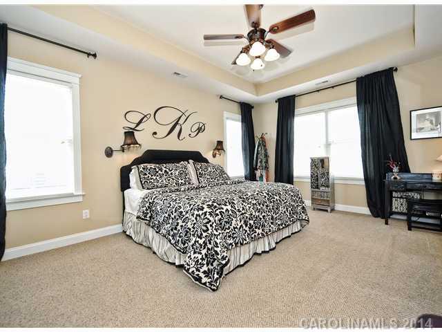1862 2nd Baxter Crossing Fort Mill, SC 29708 - Photo 10 of 16 a bedroom with a bed a dresser and a large window