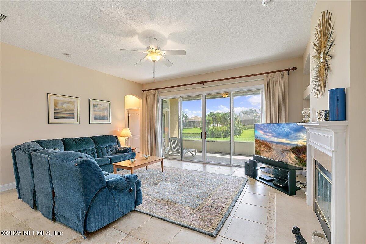 4907 Reed Island Trail Jacksonville, FL 32225 - Photo 11 of 25 a living room with furniture and a floor to ceiling window