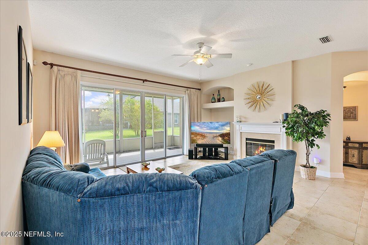 4907 Reed Island Trail Jacksonville, FL 32225 - Photo 12 of 25 a living room with furniture and a fireplace