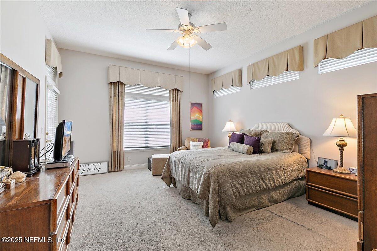 4907 Reed Island Trail Jacksonville, FL 32225 - Photo 16 of 25 a bedroom with a bed and a flat screen tv