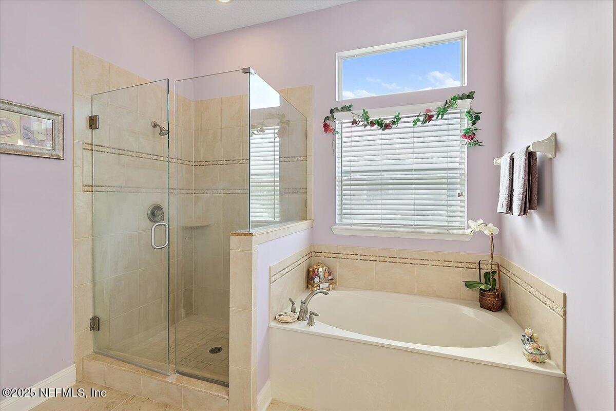 4907 Reed Island Trail Jacksonville, FL 32225 - Photo 18 of 25 a bathroom with a bathtub and a shower