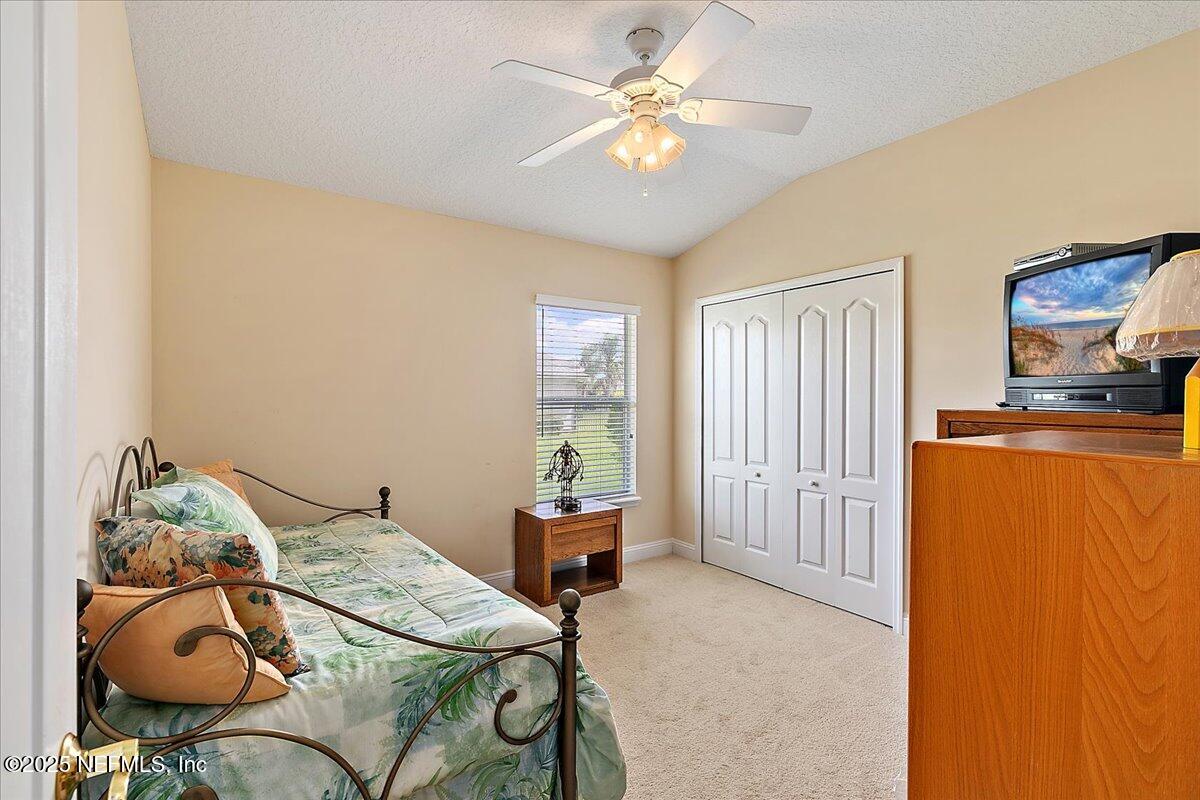 4907 Reed Island Trail Jacksonville, FL 32225 - Photo 19 of 25 a bedroom with a bed and ceiling fan