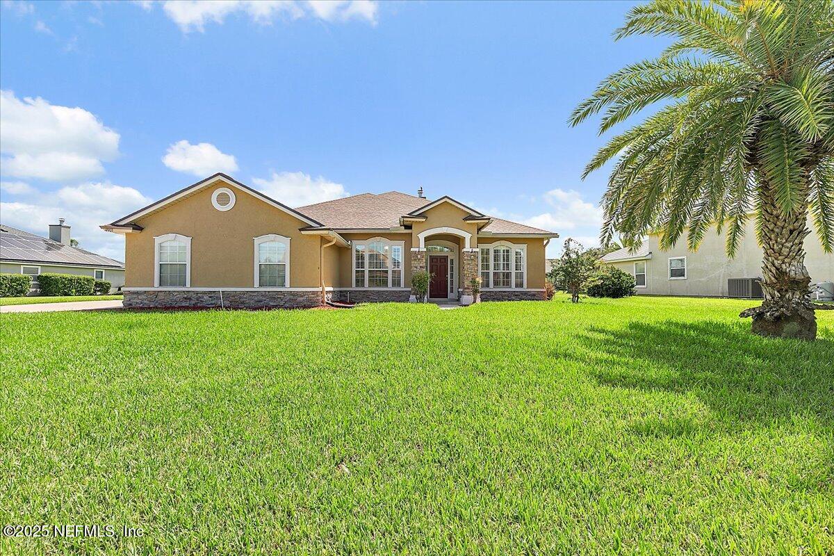 4907 Reed Island Trail Jacksonville, FL 32225 - Photo 2 of 25 a front view of house with yard and green space