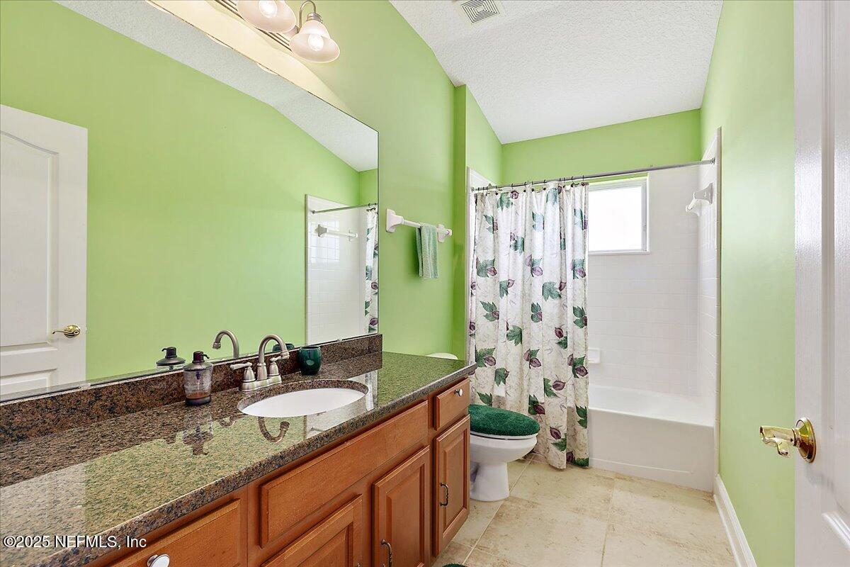4907 Reed Island Trail Jacksonville, FL 32225 - Photo 21 of 25 a bathroom with a granite countertop sink and a mirror