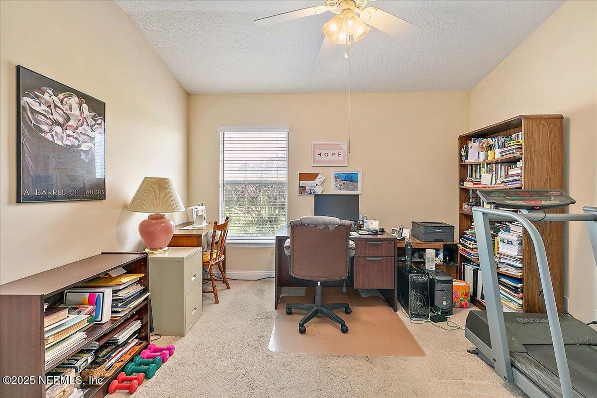 4907 Reed Island Trail Jacksonville, FL 32225 - Photo 22 of 25 a view of a workspace with furniture and a window