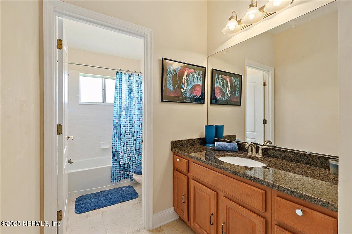 4907 Reed Island Trail Jacksonville, FL 32225 - Photo 23 of 25 a bathroom with a sink a vanity and a mirror