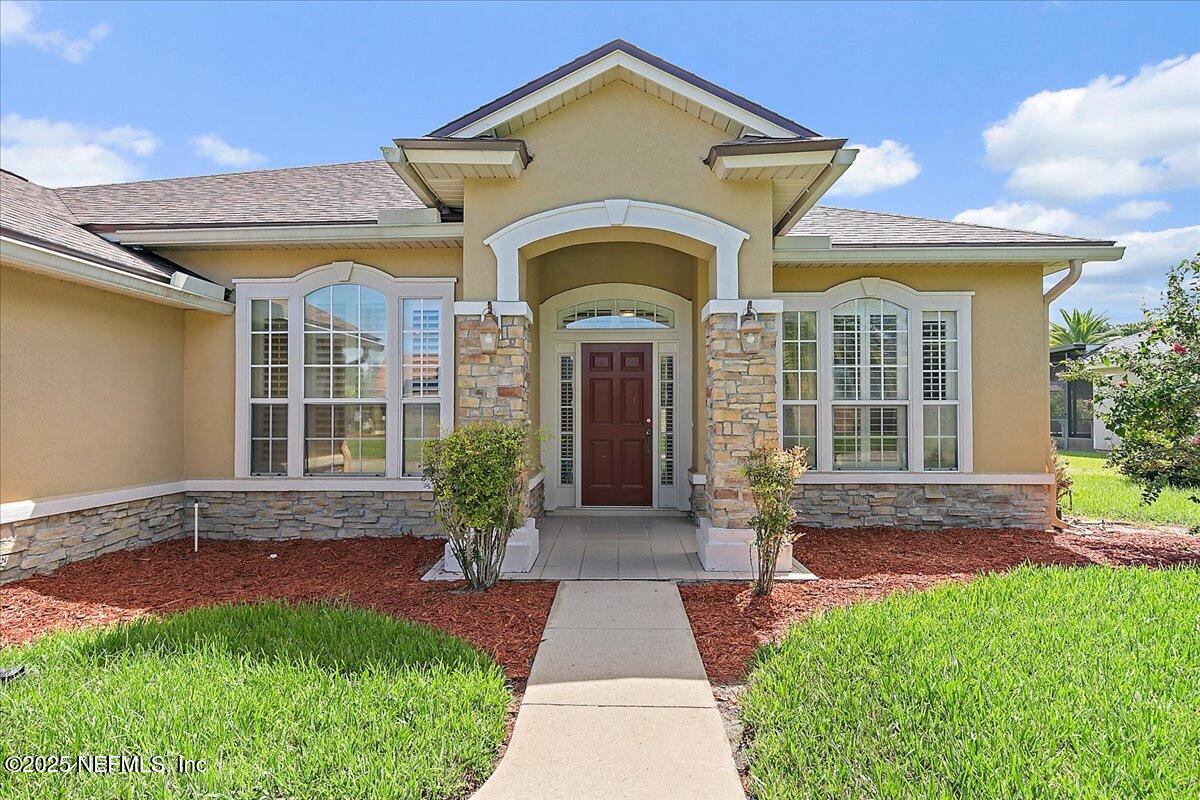 4907 Reed Island Trail Jacksonville, FL 32225 - Photo 3 of 25 a front view of a house with garden