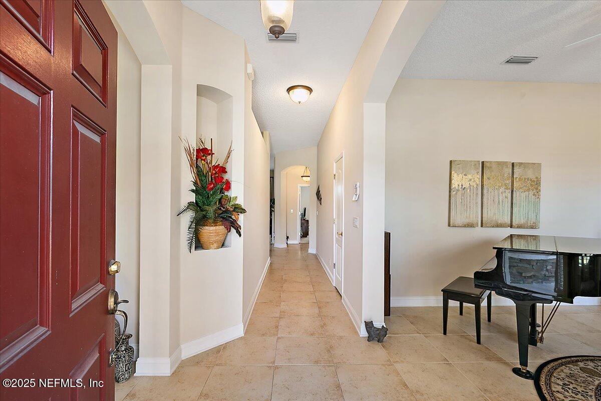 4907 Reed Island Trail Jacksonville, FL 32225 - Photo 4 of 25 a view of a hallway with furniture and a livingroom